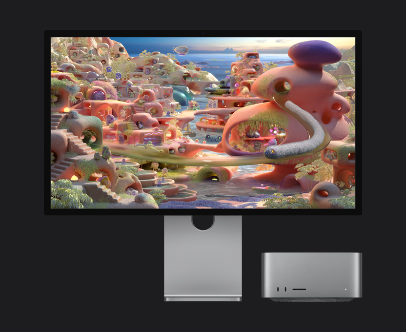 Dalam lanskap kartun di Studio Display XDR dengan Mac Studio yang terselip di bawahnya, makhluk menyerupai cacing muncul dari terowongan dan bergerak di layar